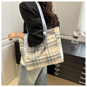 Blue and yellow plaid tote bag styled on shoulder showing large capacity for daily use