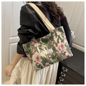 Detail of floral canvas tote bag with pink flowers and premium woven shoulder strap
