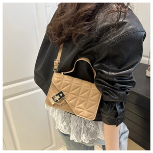 Detail of beige quilted shoulder bag with gold twist-lock and fine leather texture
