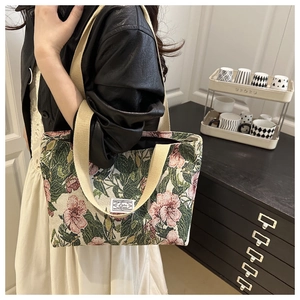 Detail of floral tapestry tote bag with cream fabric and pink flower patterns