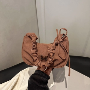 Brown corduroy shoulder bag featuring a silver butterfly buckle and pleated handle detail