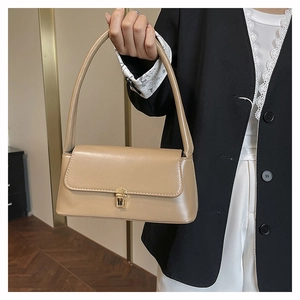 Close-up of khaki underarm bag with gold metal buckle and elegant leather texture