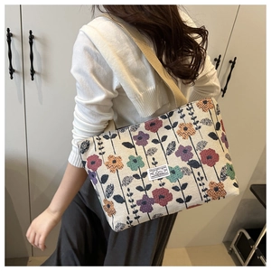 Detail of colorful floral jacquard pattern and woven strap on ethnic tote bag
