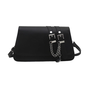 Black faux leather crossbody bag with silver buckle straps and a heart chain charm