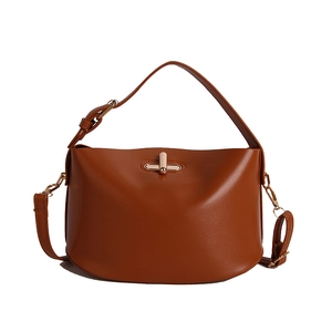 Brown leather handbag with gold metal lock and dual shoulder straps on white background
