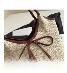 Detailed macro view of woven straw texture and premium brown leather handle stitch