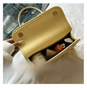 Internal view of yellow French baguette bag showing spacious storage for cosmetics