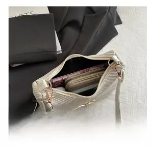 Top view of white woven shoulder bag interior showing capacity for phone and wallet