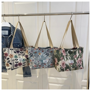 Detailed macro view of retro floral jacquard fabric textures on three stylish tote bags