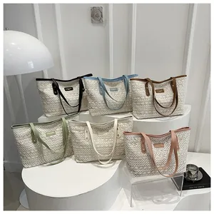 Detailed close-up of woven tote bags in multiple colors featuring PU handles and metal logo