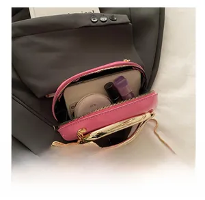 Detail view of pink acrylic mini chain bag showing interior capacity and golden handle