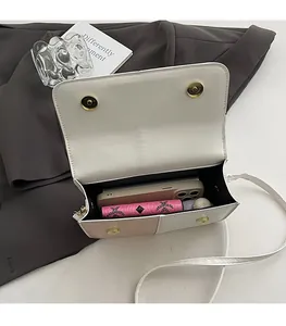 Interior view of beige leather crossbody bag showing dual magnetic closure and room for phone