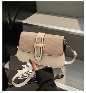 Detailed close-up of cream leather shoulder bag with champagne gold glitter flap texture