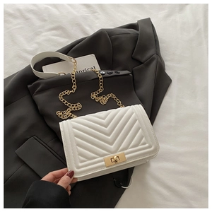 Close-up of white V-quilted faux leather bag with gold metal chain and twist-lock