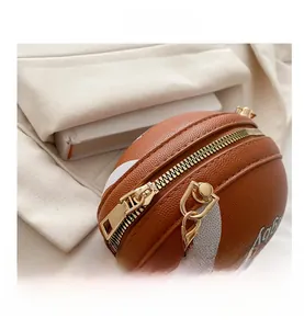 Detailed macro view of the basketball shaped mini bag featuring gold hardware and stitching