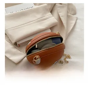 Detailed interior of a basketball-shaped chain bag showing makeup items and capacity