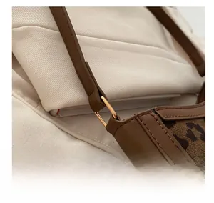 Macro detail of high-quality metal ring buckle and leopard print stitching on bag