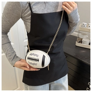 Detail of rugby-shaped crossbody bag featuring white PU leather and golden chain strap
