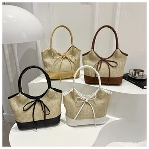 Detail of colorful straw tote bags with PU leather trim and bow knot in four colors