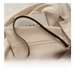 Detail of leopard print crossbody bag with gold bow clasp and durable top handle