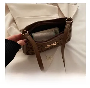 Detailed interior view of a leopard print shoulder bag showing spacious storage capacity