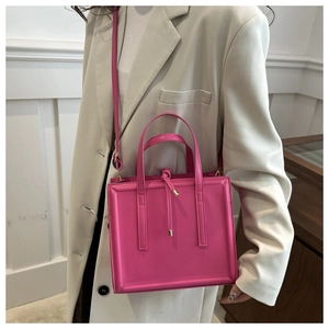 Hot pink square faux leather tote bag with elegant knots and adjustable cross-body strap