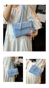 Three-frame view of light blue patent leather shoulder bag with cute cartoon charm decor