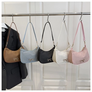 Detailed view of fashionable hobo bags in five colors with metallic bow decorations