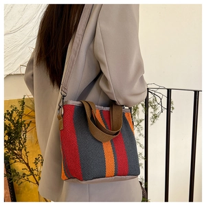 Détail du sac cabas tissé à rayures colorées avec bandoulière réglable et poignée