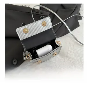 Macro view of silver carbon fiber texture mini bag showing space for wireless earphones