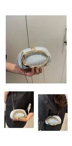 Detail of light blue glossy mini bag featuring large gold C-shaped metal handle and chain