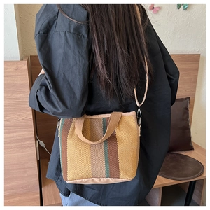 Multi-colored striped woven tote bag with adjustable shoulder strap and sturdy handle