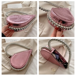 Detail of pink heart-shaped evening bag with crystal handles and interior storage