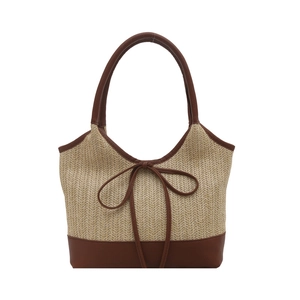 Straw beach tote bag with contrast leather trim and bow detail for summer vacations