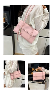 Pink PU leather rectangular underarm bag with woven charm in a modern kitchen scene