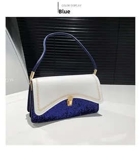 Detail of blue and white sequined shoulder bag with gold metal clasp and stitching
