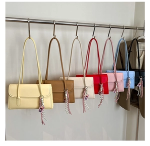 Detailed display of colorful rectangular PU leather flap underarm bags on a metal rack