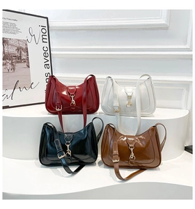 Minimalist glossy hobo bags in red, white, black, and brown on a white podium