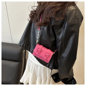 Pink mini crossbody bag with carbon fiber texture and chunky decorative chain strap