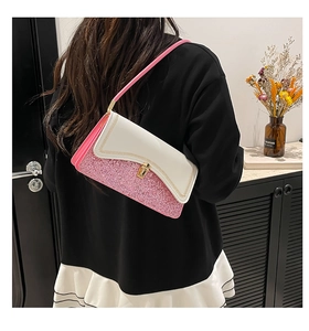 Detail of pink sequins and white leather underarm bag with gold wave embroidery