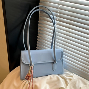 Minimalist light blue PU leather shoulder bag with long straps and cartoon pendant charm