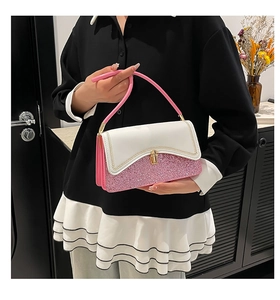 Detail of pink sequin patchwork bag with gold metal clasp and wavy stitching