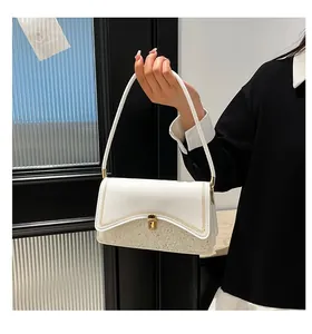 Detail of white sequin shoulder bag with golden buckle and metallic chain trim