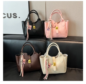 Collection of lychee grain leather bucket handbags in black, pink, brown, and cream