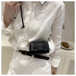 Chic black mini crossbody bag with carbon fiber texture and acrylic chain details
