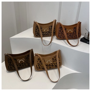 Leopard print underarm bags with metallic bow detail displayed in four earthy color tones