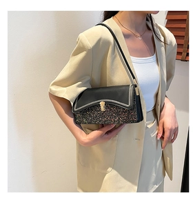 Detail of black leather shoulder bag with colorful sequins and gold square lock