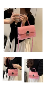 Pink woven texture crossbody bag with metal oval lock and adjustable shoulder strap