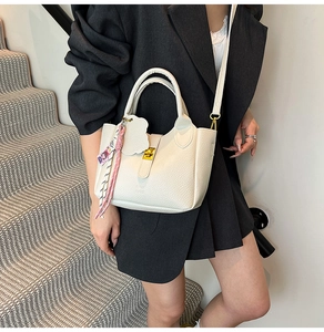 Elegant white litchi grain bucket bag with silk scarf detail and gold hardware