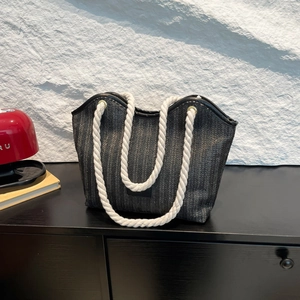 Stylish large black woven straw tote bag with durable white rope handles for summer beach